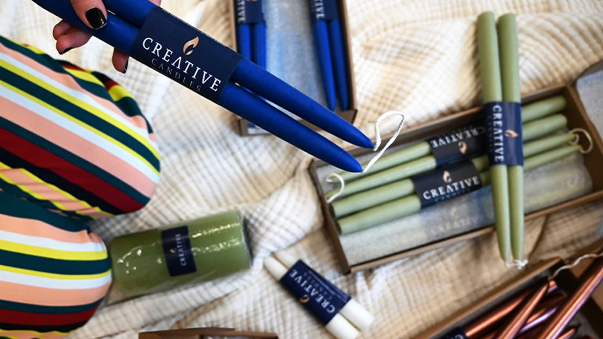 3-pair boxes of taper candles in multiple colors.