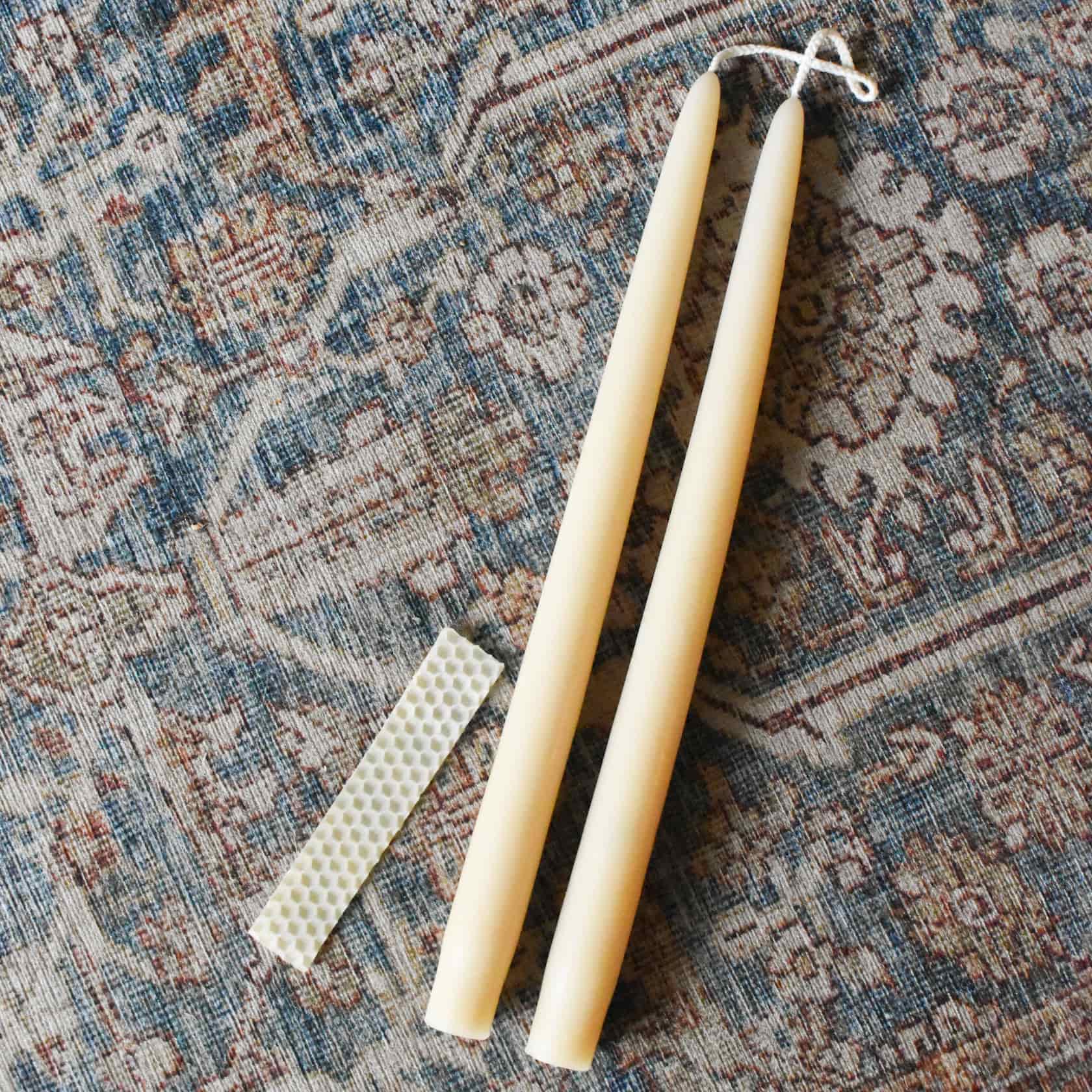Beeswax pillar candle pair next to beeswax strip
