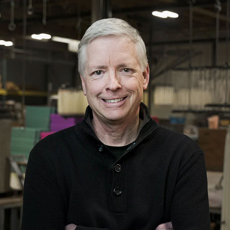 Keith Espelien, owner of Creative Candles, poses in front of a candle manufacturing facility