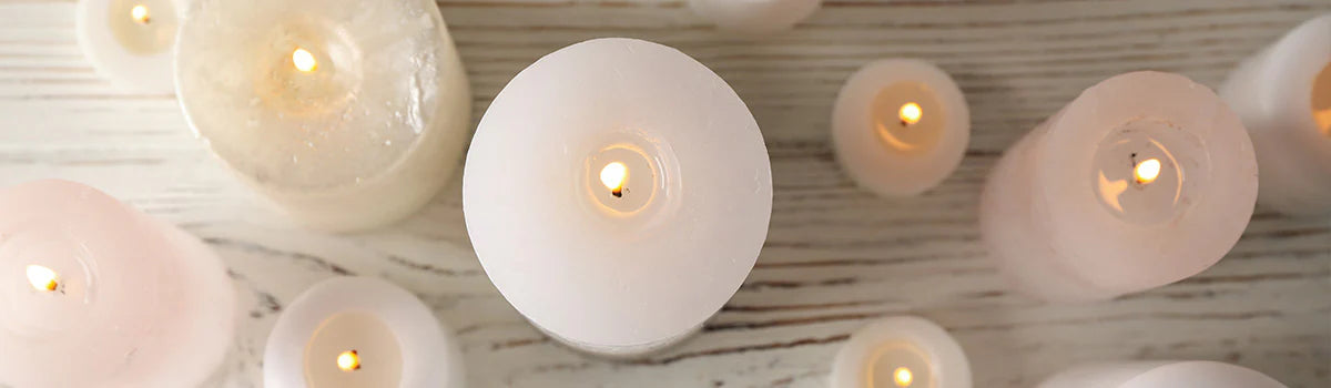 Upper view of white pillar candles burning 