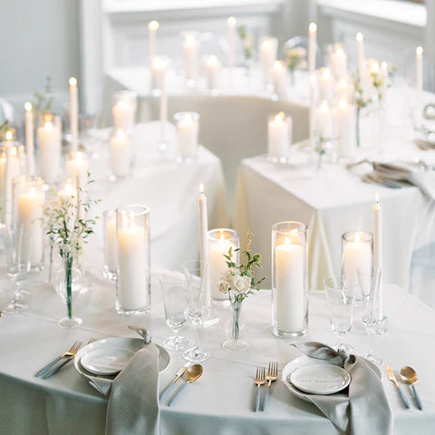 White 3" pillar and taper candles displayed on wedding venue table setting